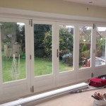 Double glazed hardwood bi-fold doors painted white